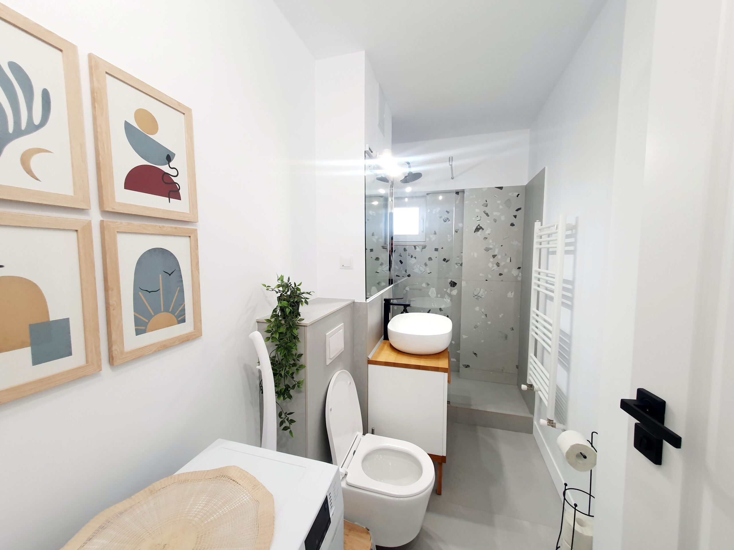Sleek and modern minimalist bathroom interior with abstract art and elegant fixtures.